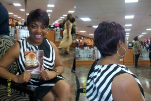 Sherri (who is holding a copy of my book) shows off her Sleek Angle wig from the front and the back...